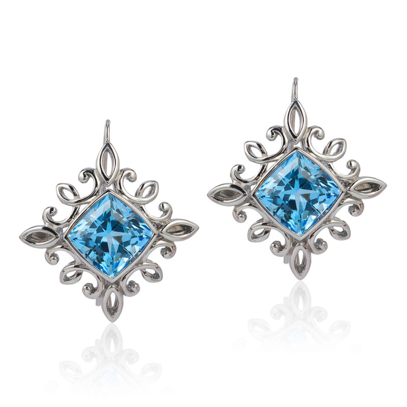 “Calligraphy" earrings in palladium featuring 17.01 carat pair of Blue Topaz; “swan-neck” wires with locking backs.