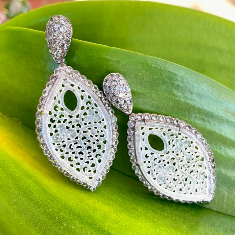 Drop Earrings in 18 karat blackened white gold featuring 18.27 carats pair of hand-carved, natural Icy White Jade accented by 200 pieces Green Sapphire weighing 7.17 carats; post w/ friction nut.