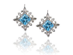 “Calligraphy" earrings in palladium featuring 17.01 ct. pair of Blue Topaz; “swan-neck” wires with locking backs.