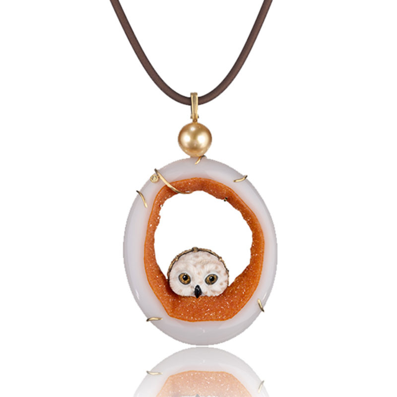 "Owlet Pendant" in 18 karat yellow gold featuring hand-carved owl head carved of white petrified palm with druzy quartz slice with 11.8 mm golden South Sea pearl; accented by one yellow diamond.