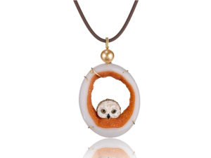 "Owlet Pendant" in 18 kt yg featuring hand-carved owl head carved of white petrified palm with druzy quartz slice with 11.8 mm golden South Sea pearl; accented by one yellow diamond.