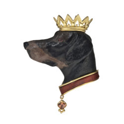 The "Faithful Companion" brooch/pendant features a hound head hand-carved from petrified wood, with a carnelian collar accented by a 0.50 carat radiant-cut Bronze Zircon dog tag; all set in 18 karat yellow gold.