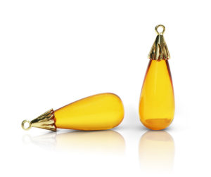 Gem drop pair in 18 karat yellow gold featuring pair of 14.96 carats golden amber smooth drops, size 25mm x 11mm, drop cap is a petal motif.