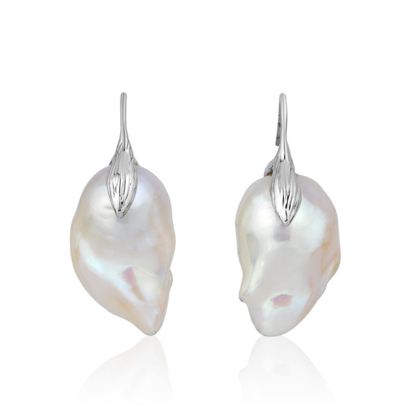 Large and luminous white, 15x21 mm, baroque "fireball" pearl earrings crafted with a leaf motif in 18-karat white gold; we make our swan-neck wire that goes through the ear shorter than most, so the earrings hang correctly and don't pull the earlobe. 