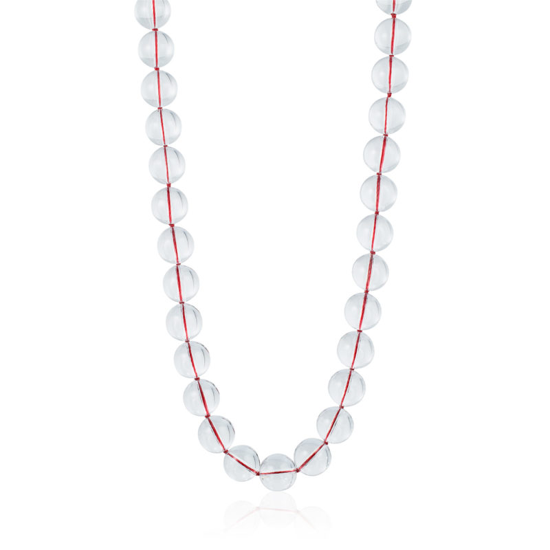 The red thread gleams through these clear “pools of light” natural quartz rock crystal beads. 