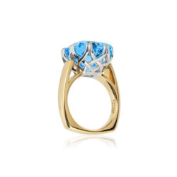 "Trellis Ring" featuring cushion-cut 10.66 carat Blue Topaz set in 18 karat white gold basket with 18 karat yellow gold shank.