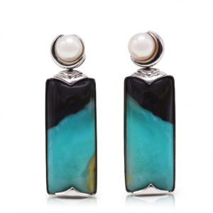 "Crescent" earrings in 18 karat white gold featuring 35.45 carat pair of natural Opalized Wood and a pair of 7-7.5 mm Freshwater Pearl; the opalized wood is found in the West Java Province of Indonesia.