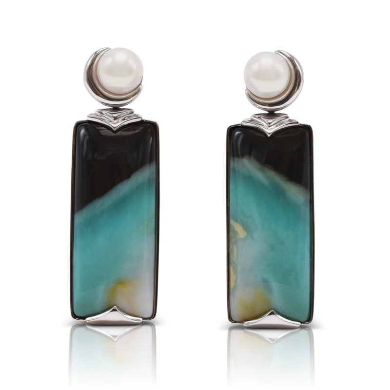 "Crescent" earrings in 18 karat white gold featuring 34.65 carats pair of natural Opalized Wood and a pair of 7-7.5 mm Freshwater Pearl; the opalized wood is found in the West Java Province of Indonesia.