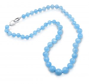 Bead necklace consisting of 51 round, smooth, Aquamarine beads graduating in size from 8.5-12 mm, strung on a knotted thread with an 18 karat white gold trigger clasp; necklace 21 inches long.