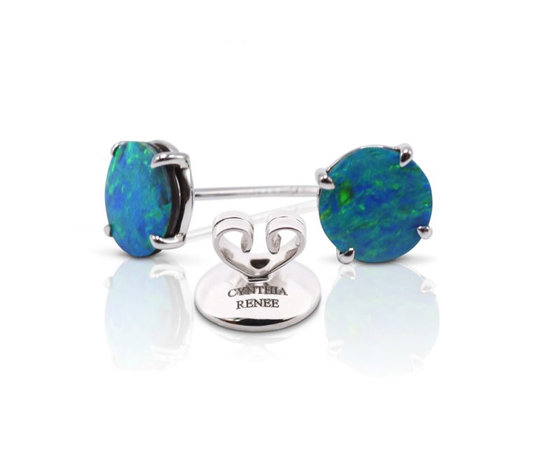 Elegant stud earring in a hand-crafted 18 karat white gold setting featuring pair of 1.89 carat Black Opal doublets; opals measure 7-mm round. 