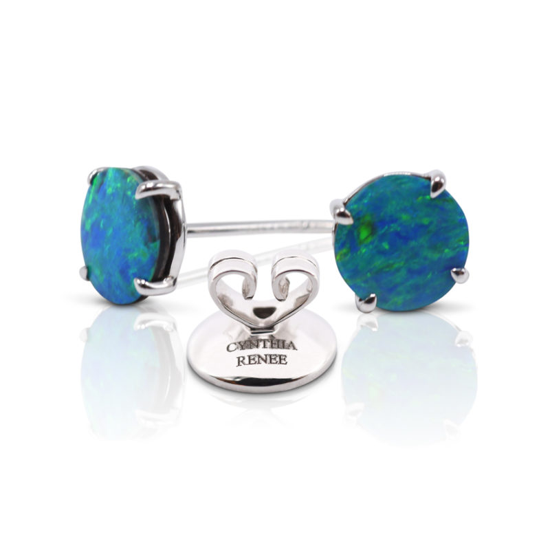 Elegant stud earring in a hand-crafted 18 karat white gold setting featuring pair of 1.89 carat Black Opal doublets; opals measure 7-mm round. 