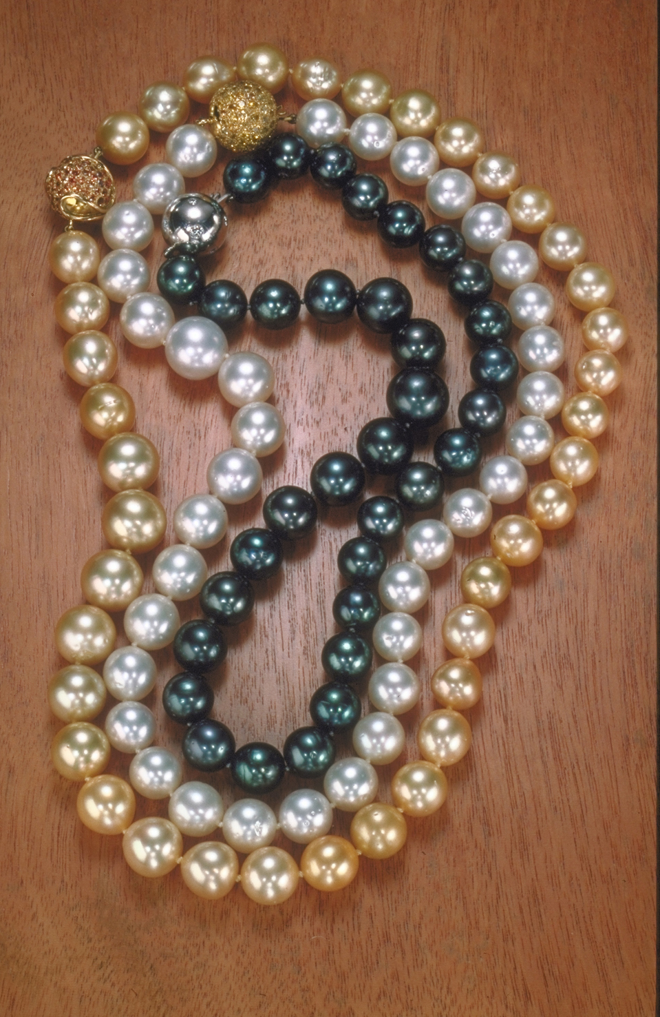 Three strands of Tahitian black, South Sea white, and gold pearls and Philippines  necklaces