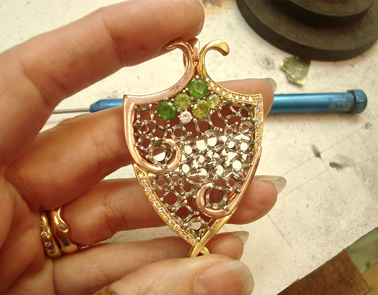 The palladium baskets soldered together and set inside the frame, with a few gems set in the baskets.