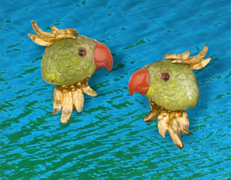 “Joy” earrings in 18-karat yellow gold featuring hand-carved Peridot parrots with Coral beaks.