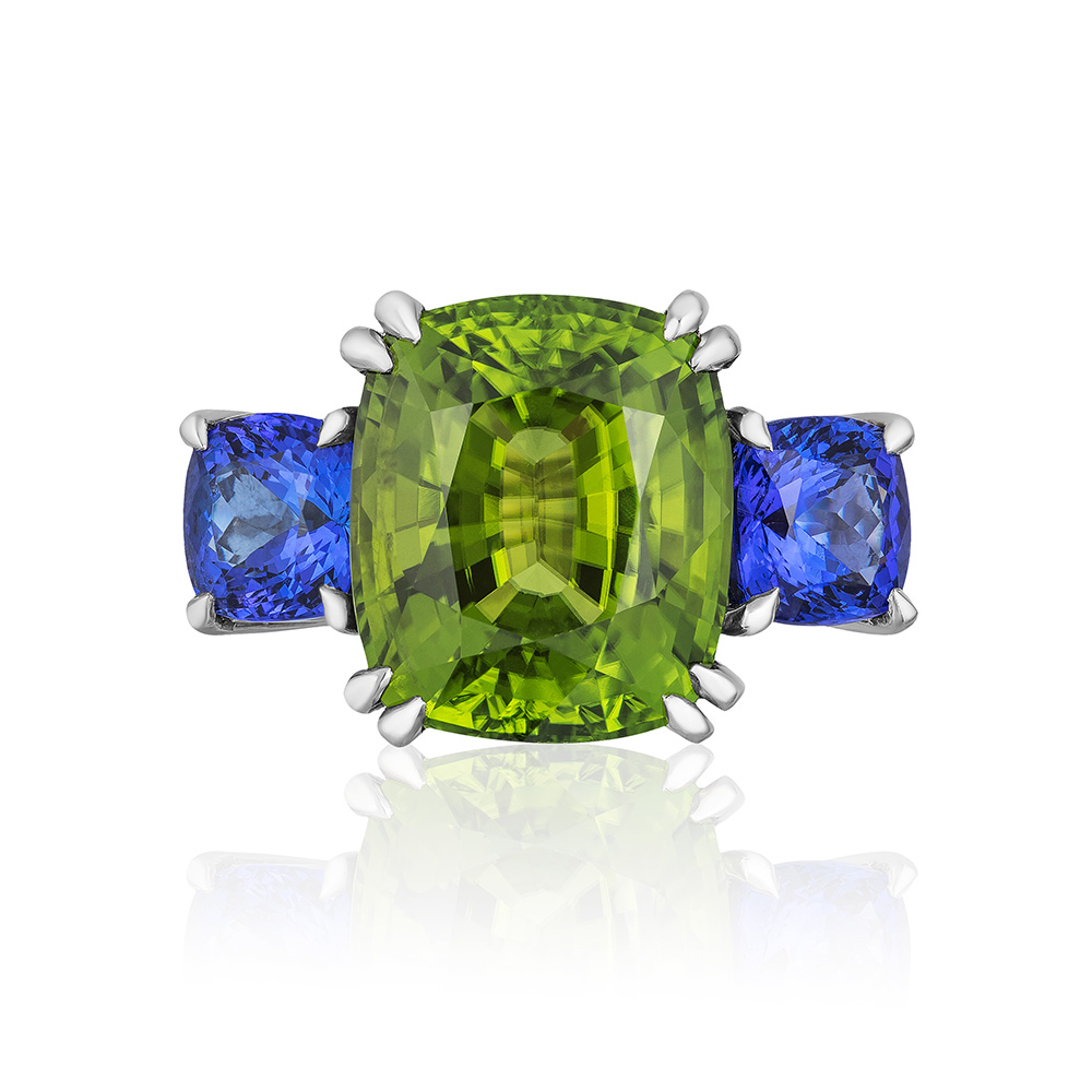 Heaven & Earth” 3-stone ring in palladium featuring stunning 16.58 carats. Burmese Peridot accented by 4.75 carat pair of Tanzanite