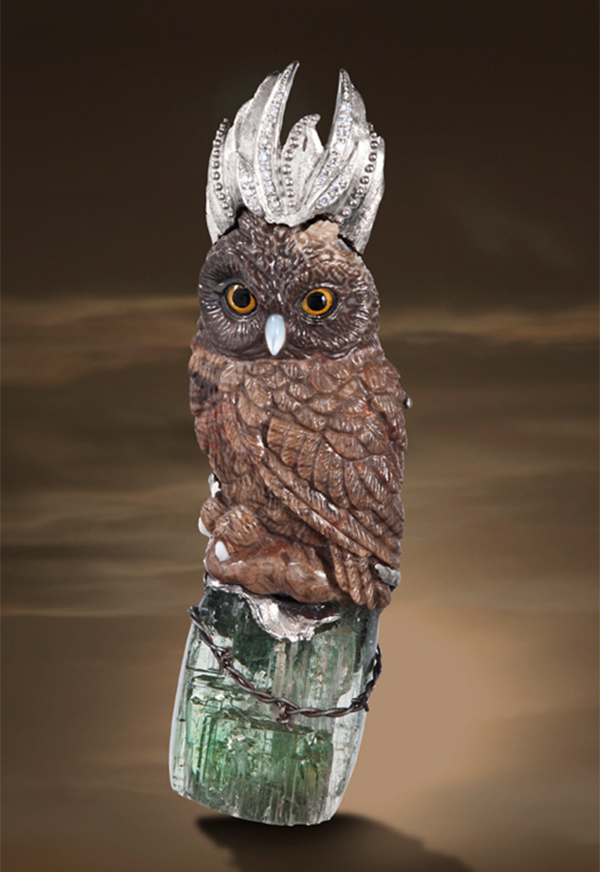 Spectrum award-winner for “Best in Palladium and Color,“ The Owl Queen” brooch/pendant features a great horned owl hand-carved in petrified palm wood; her crown of 950 palladium is accented by 0.15 carats of diamonds and hand granulation.