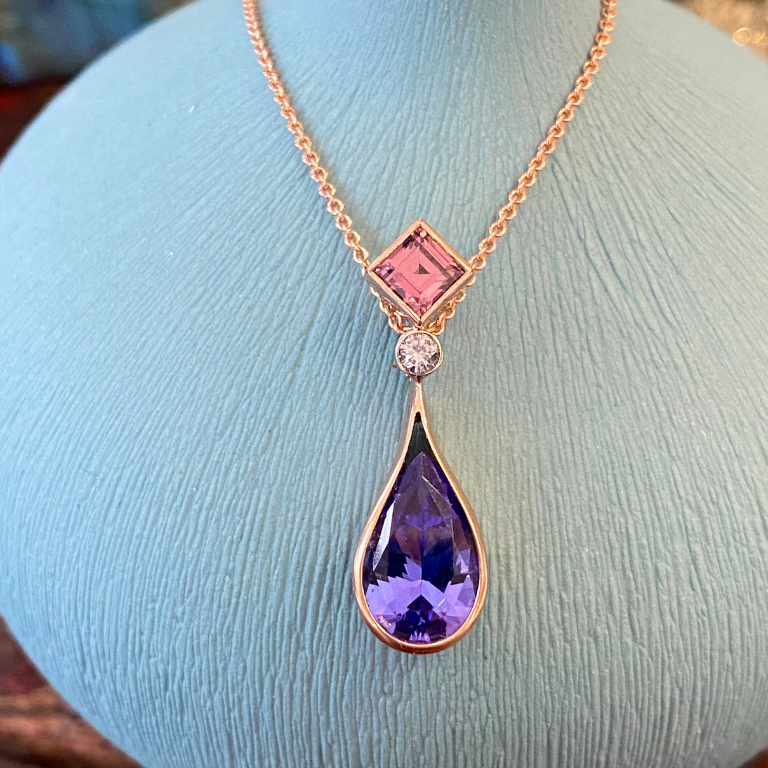 Cynthia Renee custom pendant featuring a malaia garnet, tanzanite and diamond made for my daughter's 18th birthday. This pendant has meaning beyond its beauty as it is composed of birthstones of my daughter, her father and me. 