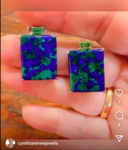 Azurite and Emerald earring held in a woman's hand