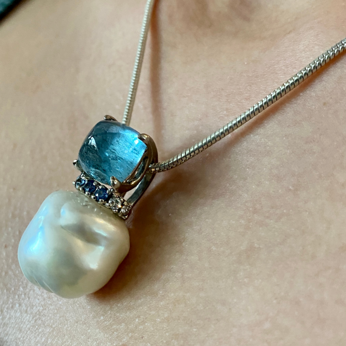 "Mermaid's Treasure" ~ Cynthia Renee Bespoke Pendant in 18 karat white gold featuring 20x21 mm Baroque Pearl, 9.31 carat Aquamarine sugarloaf cabochon, and Blue Sapphire and Diamond accent.