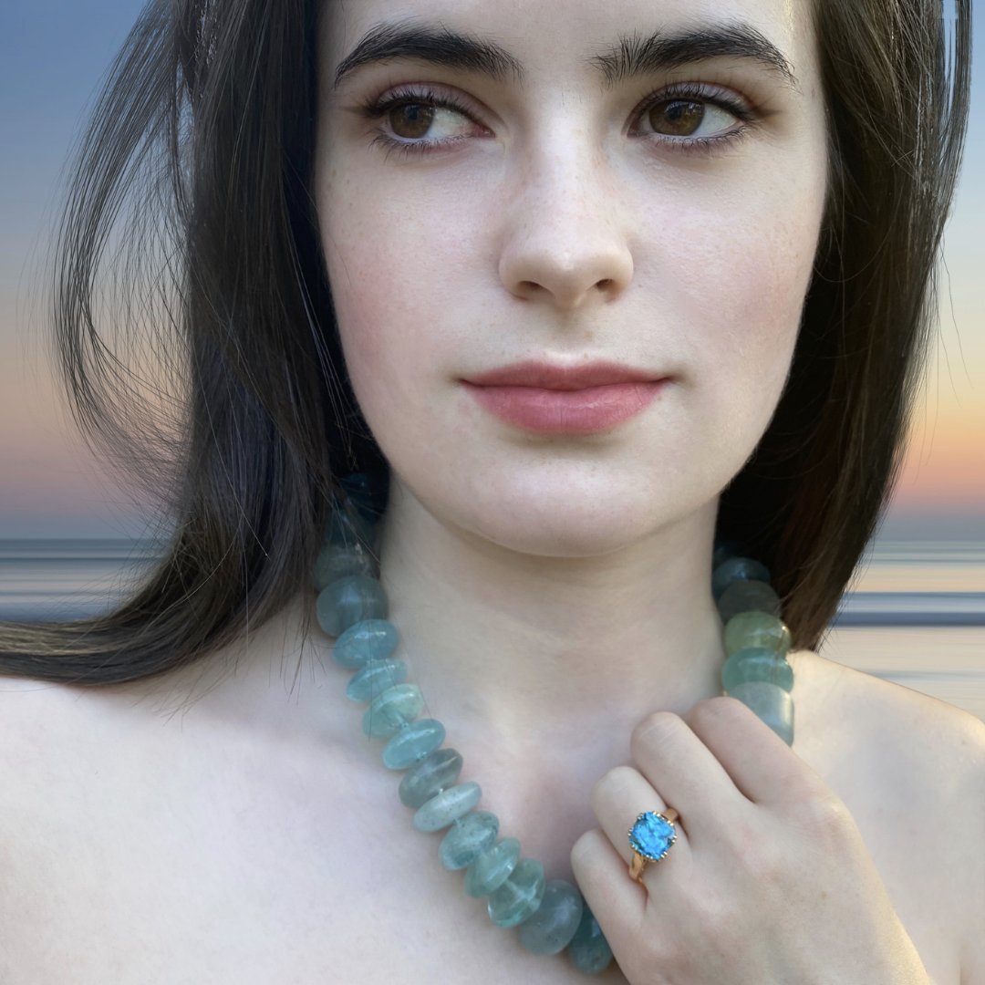 Model wearing aquamarine bead necklace