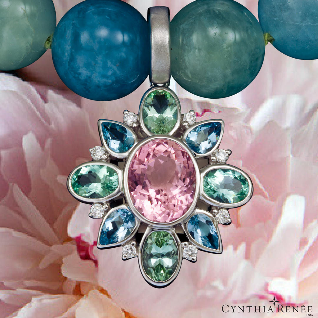 Photo 21: Small and dark aquamarine in our limited-edition Mosaic pendant. The pink is tourmaline and the green Cuprian tourmaline.