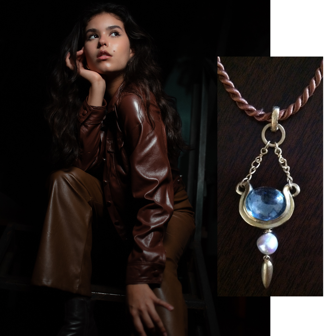 Photo 18: The bold aquamarine cabochon and gold pendant has the mass needed to balance heavier textured dark clothing. 