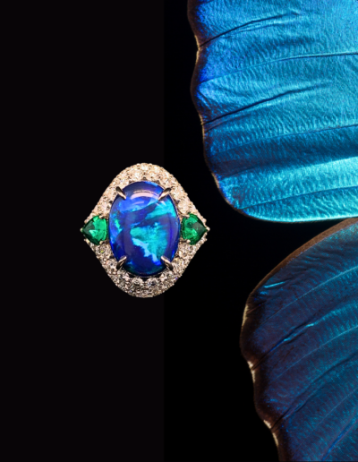 “Compassion” ~  Cynthia Renee Bespoke Ring in 14 kt white gold and platinum featuring 8.10 carat Black Opal (Coororan, Lightning Ridge, Australia) paired with 1.12 carats of Emerald (Zambia) and 1.64 carats of diamonds.