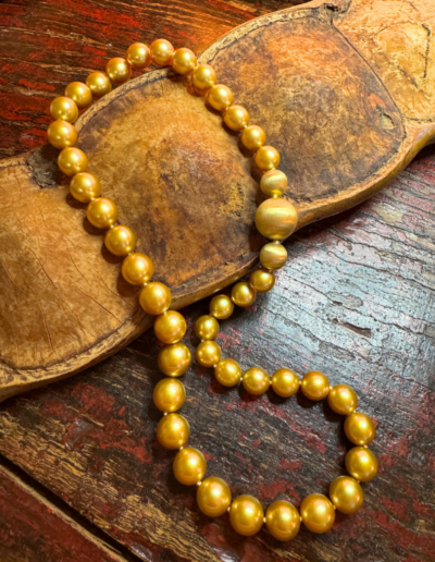 “Going for the Gold” ~ Collector’s strand of natural Golden Pearls ranging from 9.1 to 11.9 mm strung with series of three 18 karat yellow gold clasps; center round clasp can be removed so client can insert a variety of jeweled clasps from her collection.  