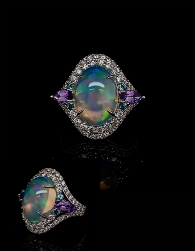 “Love” ~ Cynthia Renee Bespoke Ring in 14 karat white gold and platinum featuring 6.66 Crystal Opal (Australia) accented by a pair of 1.10 ct. Purple Sapphire, four “Paraiba” Cuprian Tourmalines weighing 0.19 cts., and 62 round diamonds weighing 1.36 carats. 