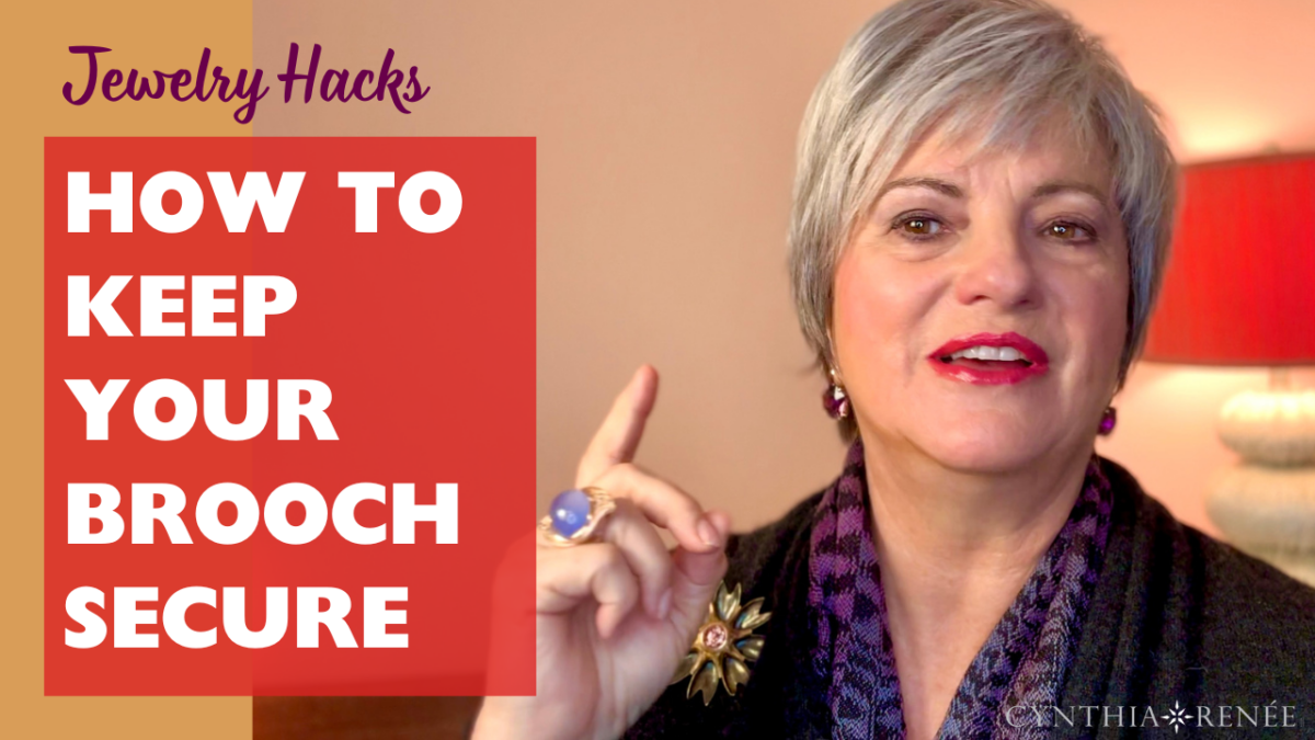 Cynthia Renee wearing blue stone ring and dark purple top with title Jewelry Hacks: How to keep your brooch secure on orange background